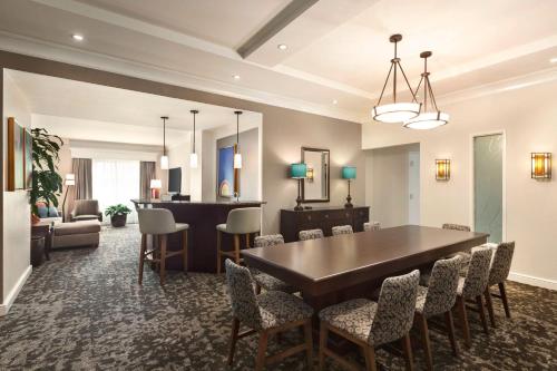 a dining room with a table and chairs at Embassy Suites by Hilton Orlando Lake Buena Vista South in Kissimmee