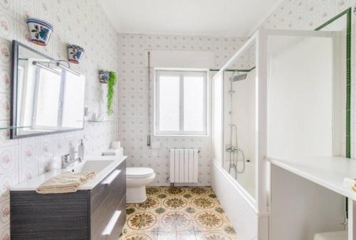 a bathroom with a tub and a toilet and a sink at CASA FINCA LA GARITA in Santillana del Mar