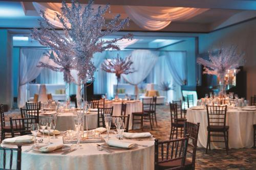 a banquet hall with tables and chairs with tablesktop at Embassy Suites by Hilton Orlando Lake Buena Vista South in Kissimmee