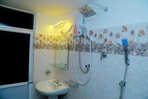 a bathroom with a shower and a sink at villa surendra in Weligama