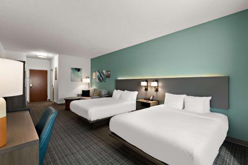 a hotel room with two beds and a desk at Comfort Inn Powell - Knoxville North in Knoxville