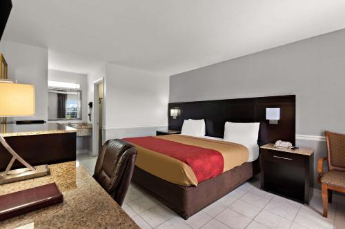 a hotel room with a bed and a bathroom at Econo Lodge Princess Anne in Princess Anne