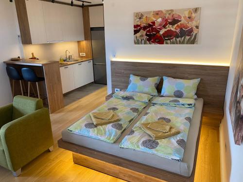 a small bedroom with a bed and a kitchen at Vrtovi Ceraka in Belgrade