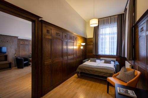 a small bedroom with a bed and a window at JUFA Hotel Bregenz in Bregenz