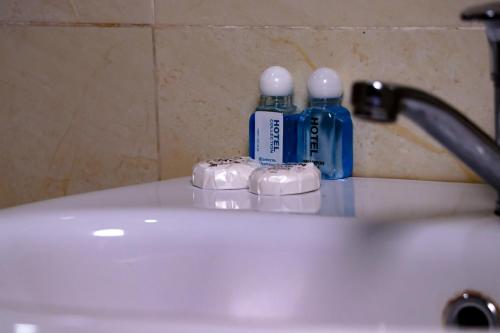 Fotih Hotel في Sergeli: وجود زجاجتين من المياه فوق حوض الحمام