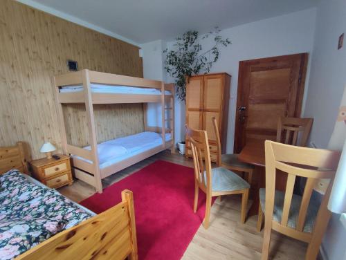 1 dormitorio con litera, mesa y sillas en Wiking en Szklarska Poręba