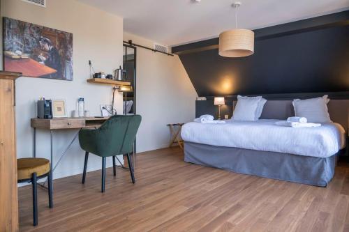 a hotel room with a large bed and a desk at Les Demeures de Varennes, BW Signature Collection in Varennes-Jarcy