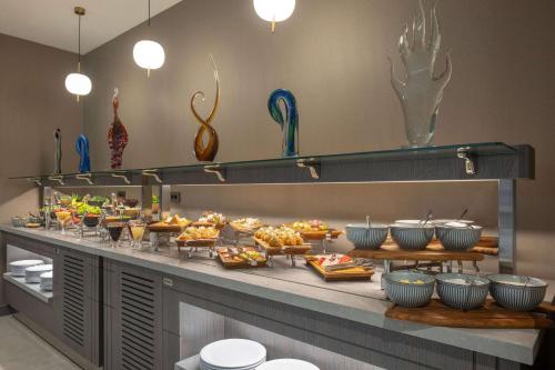 a buffet line with many different types of food at Ramada Plaza by Wyndham Batumi & Casino in Batumi