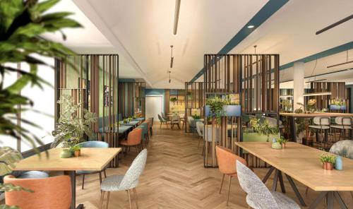 a rendering of a restaurant with tables and chairs at Hilton Garden Inn Milan Malpensa in Somma Lombardo