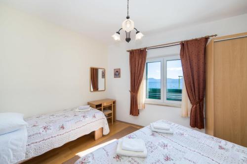 Postel nebo postele na pokoji v ubytování Apartments Dominko