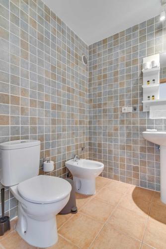 a bathroom with a toilet and a bidet and a sink at Residencial Las Candelarias 36 in Agaete