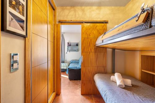 a small room with a bunk bed and a bedroom at Apartamento diseño a pie de pista in Monachil