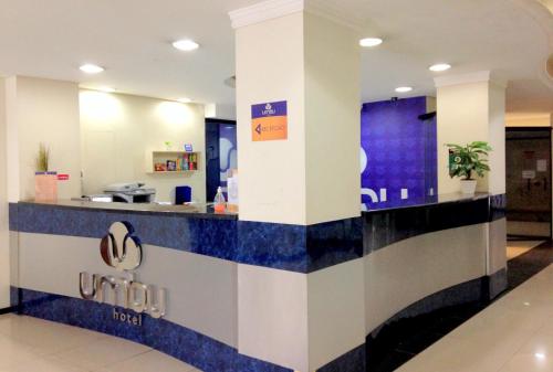 a lobby with a blue and white counter top at Umbu Hotel Porto Alegre - Centro Histórico - Prox Aeroporto 15min in Porto Alegre