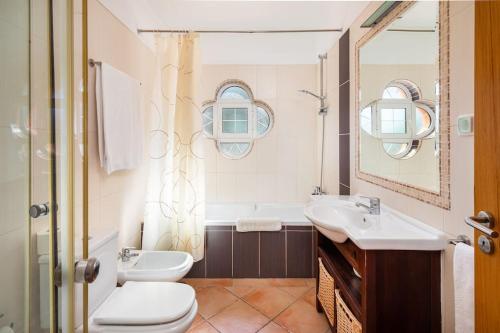 a bathroom with a sink and a toilet and a tub at Private Villa Ribeiro I Heated Pool, 4 Bed, BBQ, AC, WIFI, BEACH in Albufeira