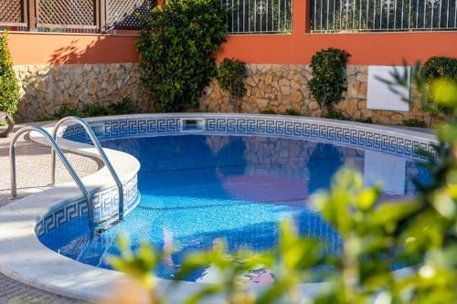 a swimming pool in front of a building at Private Villa Ribeiro I Heated Pool, 4 Bed, BBQ, AC, WIFI, BEACH in Albufeira