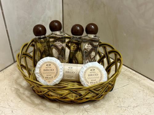 a basket with four bottles of alcohol in it at Hotel Brod - Free Parking in Sofia