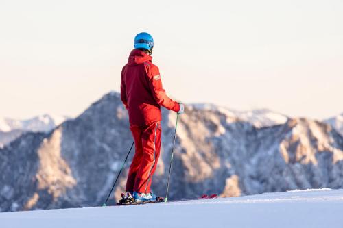 a man on skis standing on top of a mountain at Hotel Pirchnerhof in Reith im Alpbachtal