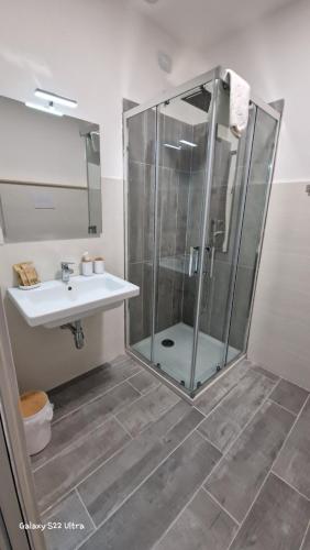 a bathroom with a shower and a sink at Terry's House in Nuoro