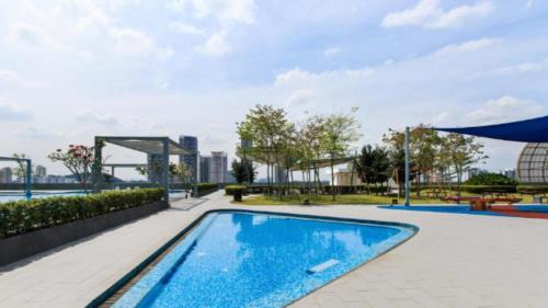 a swimming pool at a hotel at Encorp Strand Lovely 2BR Condo at Kota Damansara in Petaling Jaya
