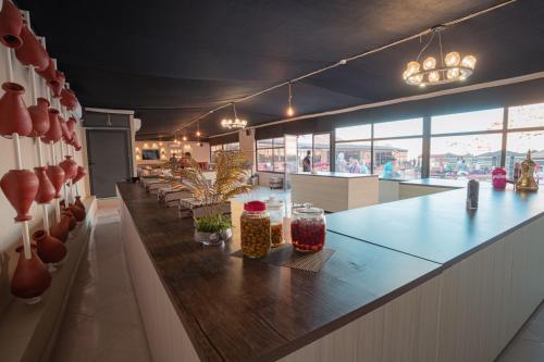 a restaurant with a long counter with vases on it at Rahayeb Desert Camp in Wadi Rum