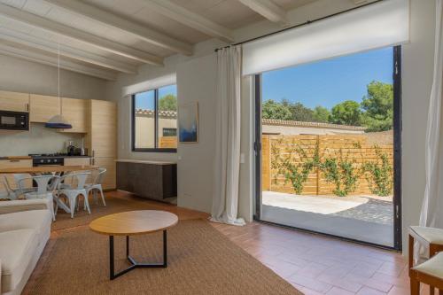 a living room with a large sliding glass door at Casa de campo Masos de Pals con parking y piscina in Pals