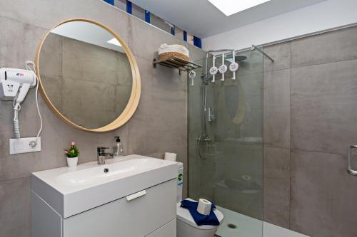a bathroom with a shower and a sink and a mirror at Villa Valentina Private Pool Playa Blanca By PVL in Playa Blanca