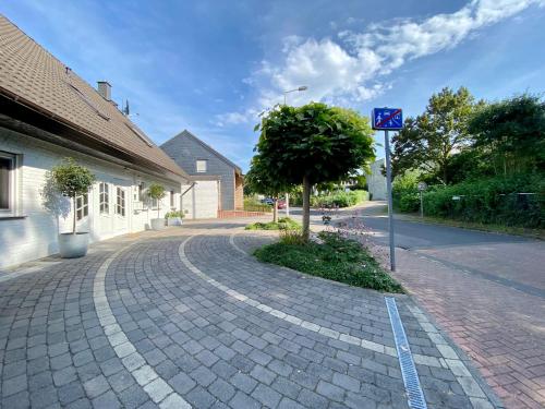 a brick road with a tree on the side of a building at Nettetal Oase in Nettetal