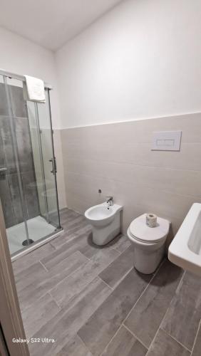 a bathroom with a toilet and a shower and a sink at Terry's House in Nuoro