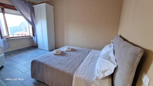 a bedroom with a bed with two candles on it at Terry's House in Nuoro