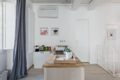a kitchen with white walls and a wooden counter top at La Casetta a Monti in Rome