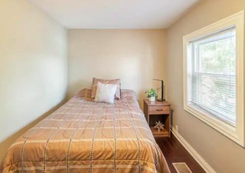 a bedroom with a bed and a window at Elegant 3 Bed One Bath At West Side in New York