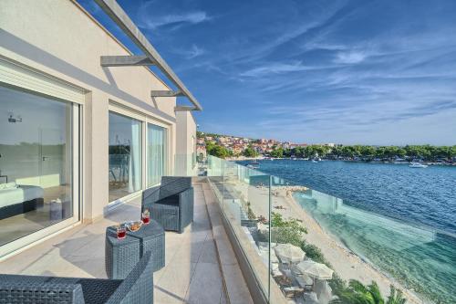 a balcony of a house with a view of the water at Livingstone Beach House in Trogir