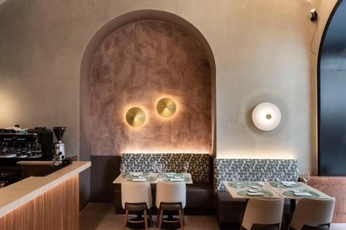 a restaurant with a table and chairs and a wall at numa I Linea in Rome