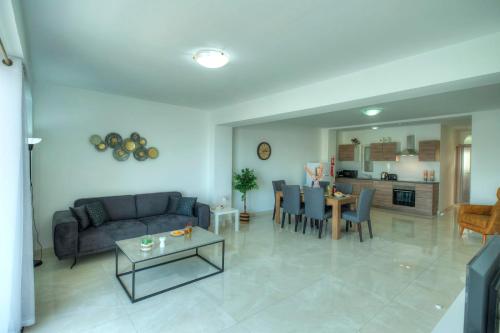 a living room with a couch and a table at Bright & modern 2bedrooms with sea views GOGZR1-2 in Il-Gżira
