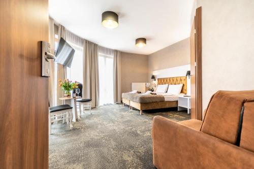 Postel nebo postele na pokoji v ubytování Promocje Amber Park Spa