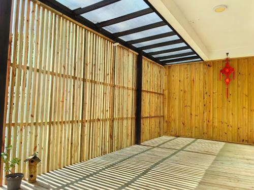 a room with a wooden wall with a window at Sunny in Florianópolis