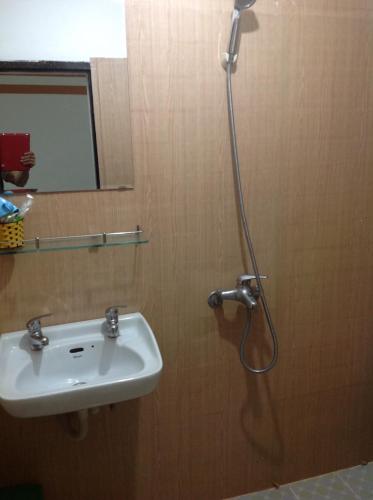 a bathroom with a sink and a shower at Ngoc Binh Hotel in Hue
