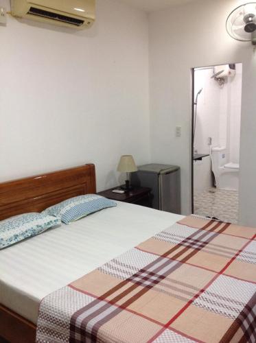 a bedroom with a bed and a bathroom at Ngoc Binh Hotel in Hue