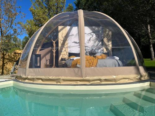 a tent sitting on top of a swimming pool at Le Clos FMR Insolite - "F"anny Carcassonne in Malves-en-Minervois