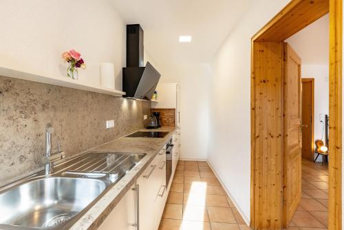 a kitchen with a sink and a counter top at Ferienwohnungen Metzgerpost in Altensteig