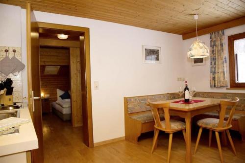 a kitchen with a table and chairs in a room at Haus Trantrauas in Gaschurn