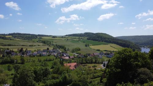 a small village in a green field with a lake at Ferienhaus Auszeyt für Zwei in Waldeck