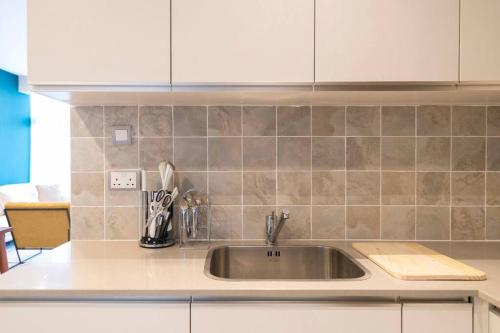 a kitchen with a sink and a counter top at SkyNest by Merlion - Urban luxury apartment in Nairobi