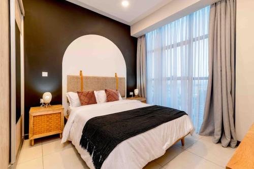 a bedroom with a large bed and a large window at SkyNest by Merlion - 14th Floor - Urban Luxury - Self Check-in in Nairobi