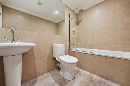 a bathroom with a toilet and a sink and a bath tub at (G1) Elegant 2 bed Blythswood Apartment in Glasgow
