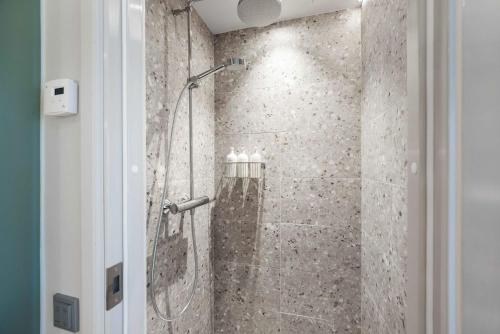 a bathroom with a shower with a glass door at Original Sokos Hotel Seurahuone Savonlinna in Savonlinna