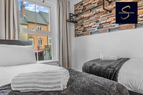 a bedroom with two beds and a window at LUXE 3 BED - Central Reading - Free Parking in Reading