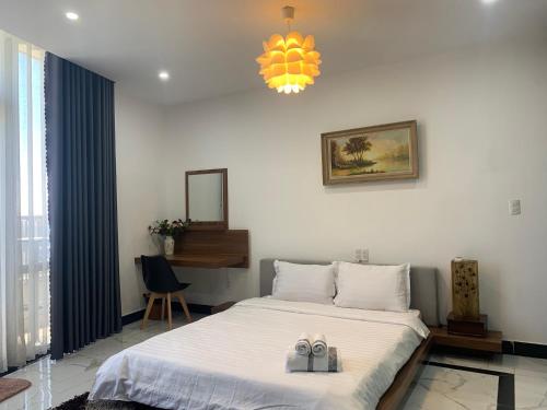 a bedroom with a bed with two shoes on it at Panaroma Apartment Đà Lạt in Da Lat