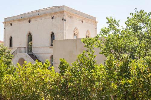 a building with a staircase on the side of it at Villa Boscarino Boutique Hotel & Spa in Ragusa
