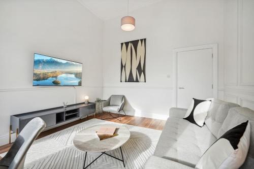 a living room with a couch and a table at (G2) Central 1 Bed Blythswood Flat in Glasgow